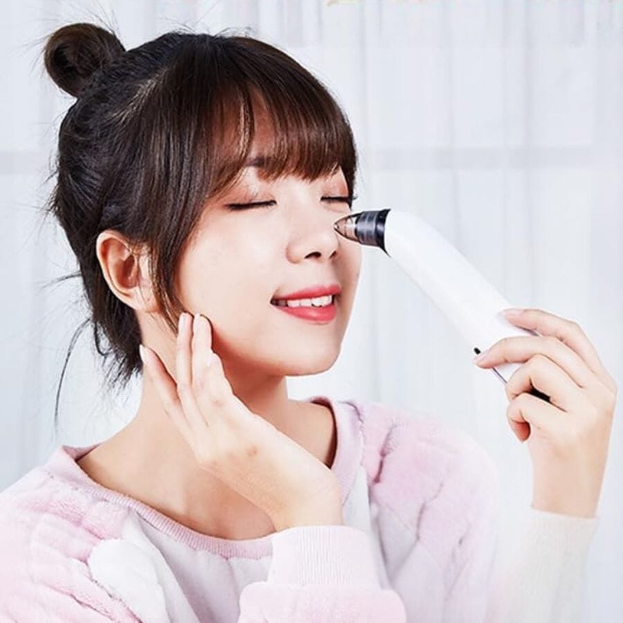 Aurenza Blackhead Remover Pore Vacuum Cleaner shown in use, with sleek black design and clear suction head for facial blackhead extraction.