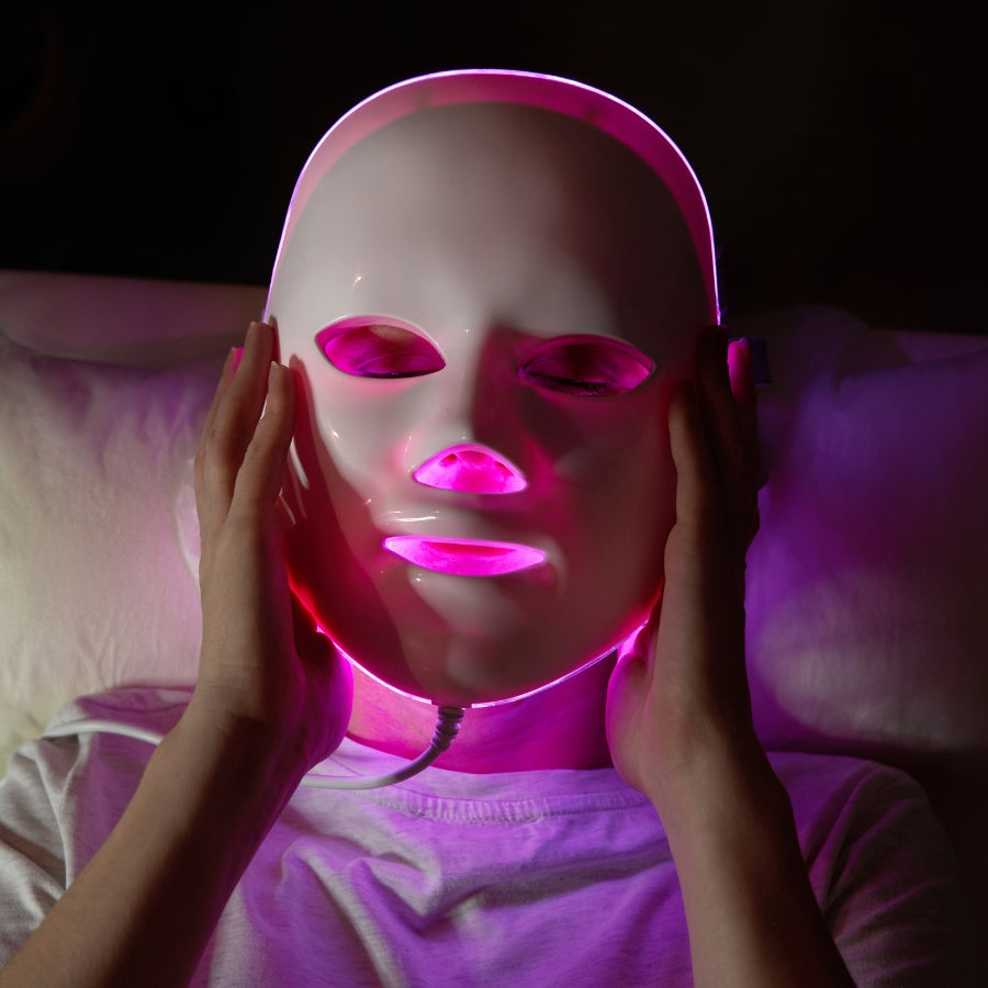 Aurenza Shop Face Mask Light Therapy Pro showing a sleek black facial mask with adjustable straps and LED light panels for skin treatment.