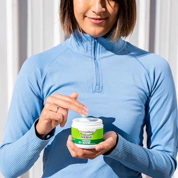 Aurenza Shop pain relief cream jar with label showing product name and ingredients, placed on a neutral background.