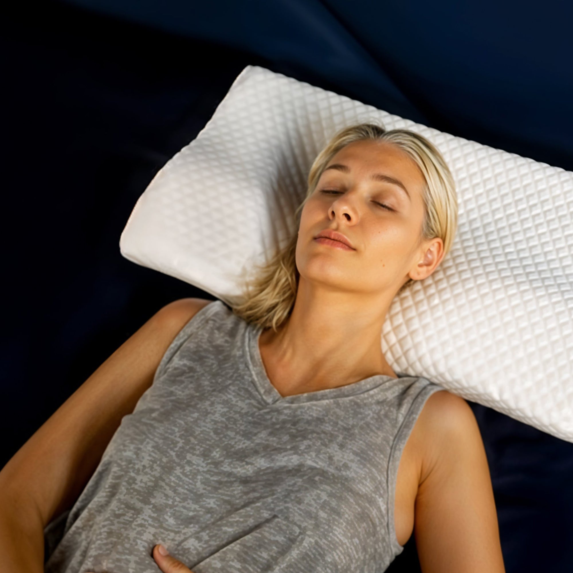 White cervical pillow from Aurenza Shop designed for neck support and relief from discomfort.