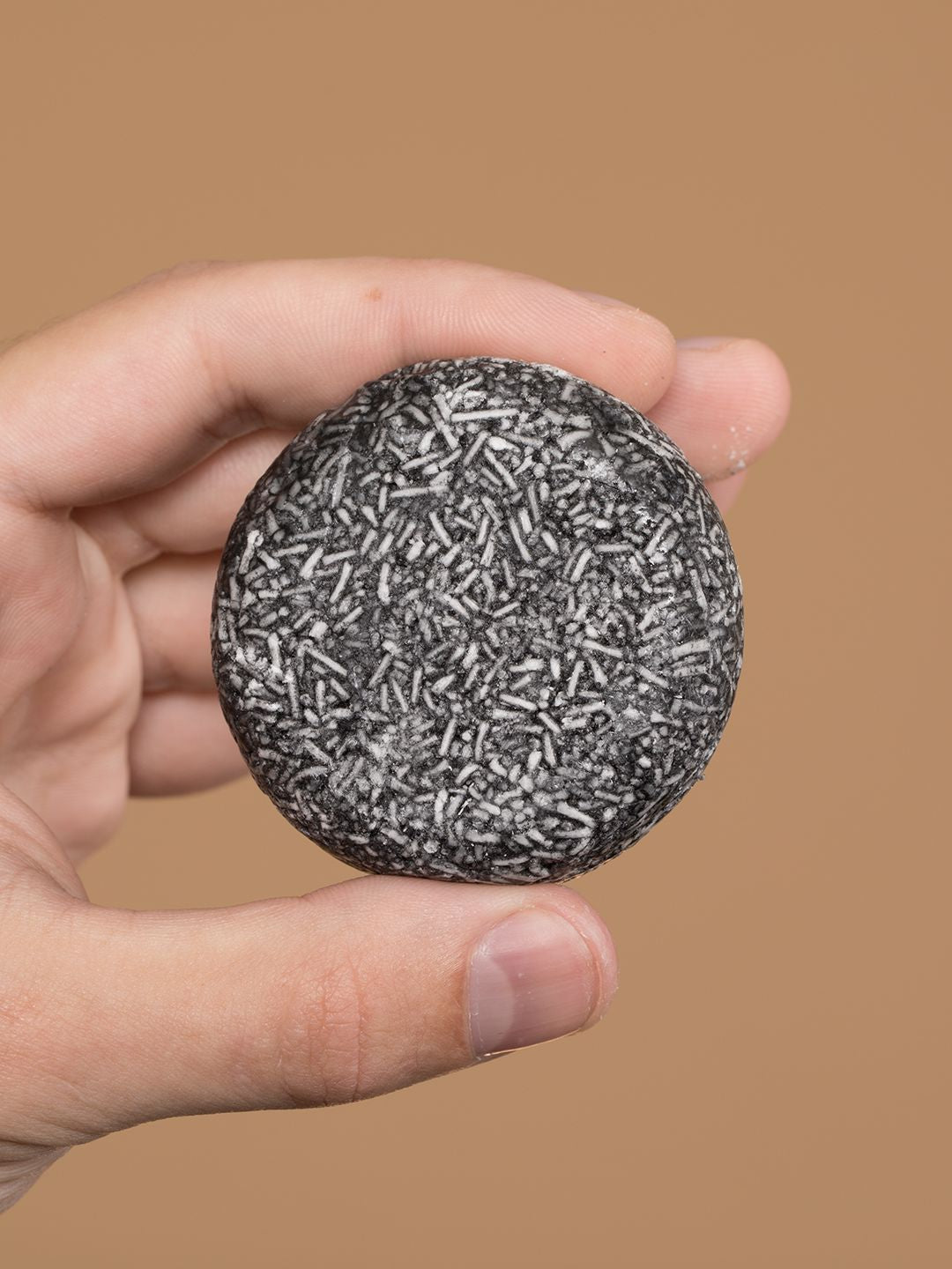 Gray Reverse Bar shampoo bar by Aurenza Shop, shown in a natural setting with its sleek gray packaging and product details.