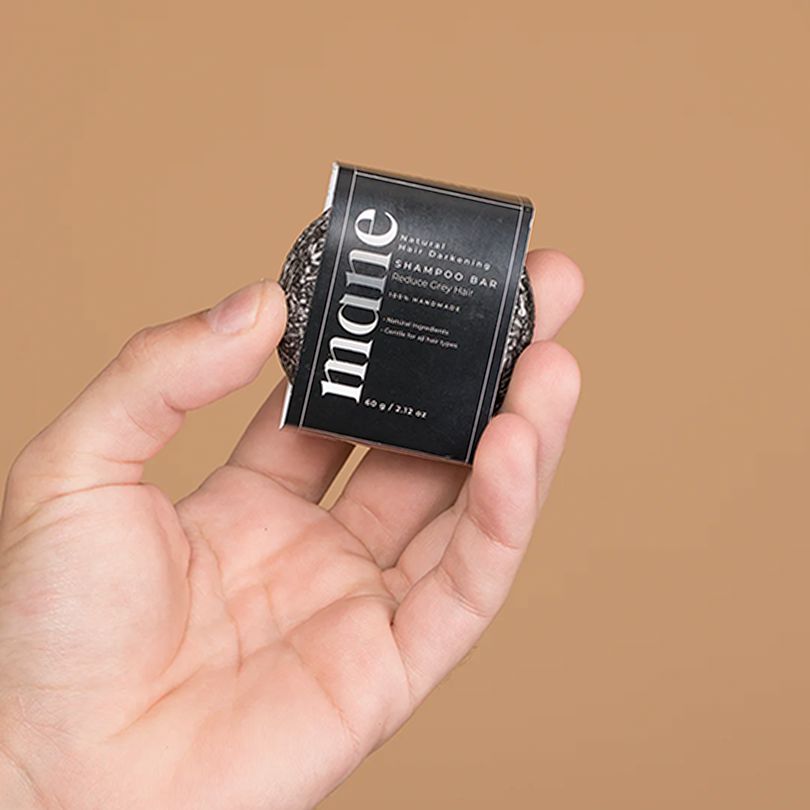 Gray Reverse Bar shampoo bar by Aurenza Shop, shown in a natural setting, highlighting its sleek gray design and eco-friendly packaging.